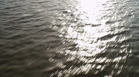 Low flight over sun glare on rushing water. Shot in 2011. Stock Footage 59215461