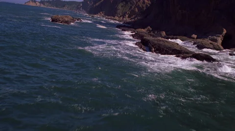 Low flight paralleling Pacific shoreline Stock Footage 59384282