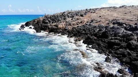Low fly along Crete beach, blue sea waves crashing into rocky coast, Greece Stock Footage 101070839