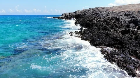 Low fly along sea beach and sharp volcanic rocks Stock Footage 100671251