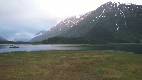 Low Fly Over Lake Toward Snow Covered Mountains - Alaska Stock Footage 217831303