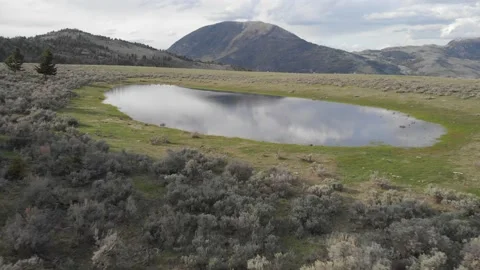 Low fly over mountain pond Stock Footage 166424545