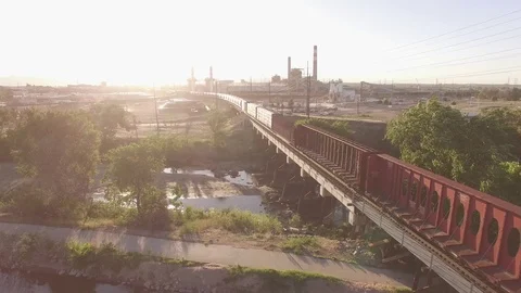 Low fly over a train on a bridge Stock Footage 98844948