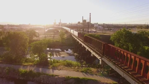 Low fly over a train on a bridge Color Corrected Stock Footage 98844949