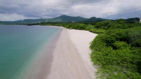 A low-flying 4K drone shot of Playa Conchal, or “Shell Beach”, and Puerto Stock Footage 257740492