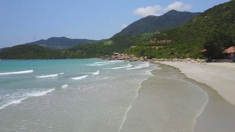 Low flying above the beach, over a a reef and blue ocean Aerial view of 動画素材 74644287