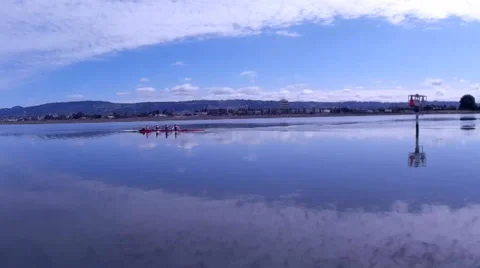 Low Flying Aerial Camera Chases Row Boats on Calm Bay Waters Stock Footage 37579811