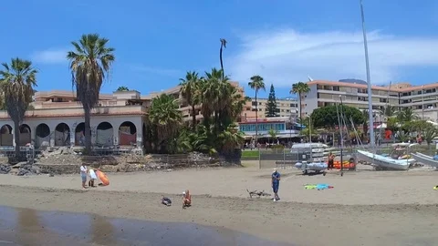 Low flying aerial drone shot of beach over sea in Los Cristianos Tenerife Spain Video stock 80271773