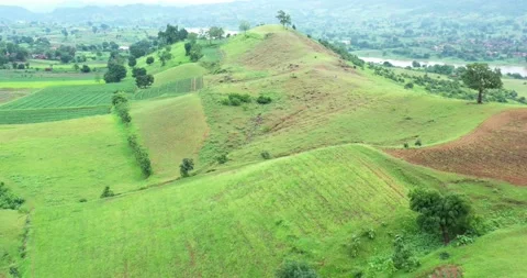 Low Flying Aerial View Over Undulating Agriculture Fields By The River Stock Footage 154820931