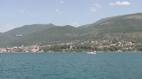 Low flying aircraft against a backdrop of yachts and sea Stock Footage 99691790