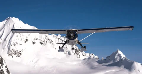 Low Flying Alaskan Ski Plane Flies Right Over Fast and Close Scenic Mountain Stock Footage 66549870