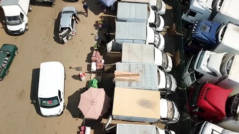 Low flying camera on the trailers on the market Stock Footage 93448970