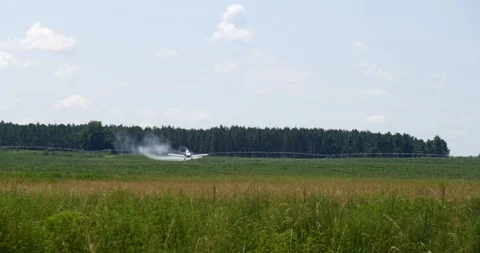 Low flying crop duster sprays chemicals then quickly gains altitude Stock Footage 114719430