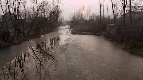 Low flying drone beautifully framing the icy textures and radiant sun Stock Footage 311020890