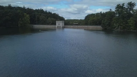 Low-flying Drone over calm reservoir and dam Stock Footage 86951345