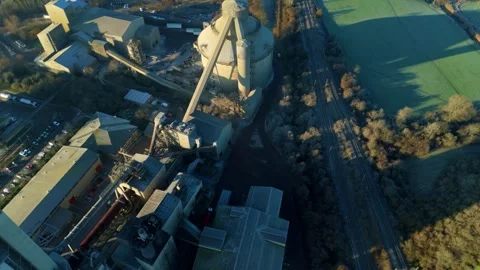 Low flying drone shot approaching the large scale industrial complex of Cemex Stock Footage 333974988