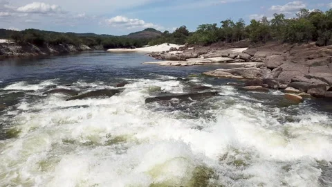 Low flying drone shot over fast flowing rapids on a tropical river in Stock Footage 155015376