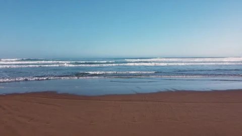 Low Flying Drone Shot - Small Waves on the Beach Stock Footage 314110225