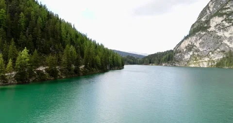 Low Flying Drone view of lake braies in the Alps. Clear and calm water in 4K Stock Footage 148535643
