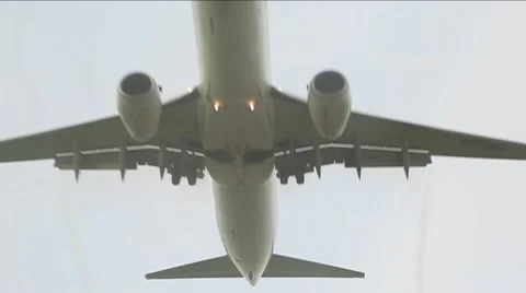 Low flying Jumbo Jet Flys overhead Stock Footage
