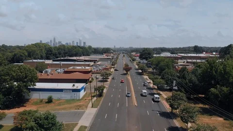 Low flying over active highway leading into city Stock Footage 93154199