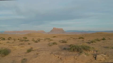 Low flying over a desert heading towards Factory Butte in Utah Stockbeeldmateriaal 140203725