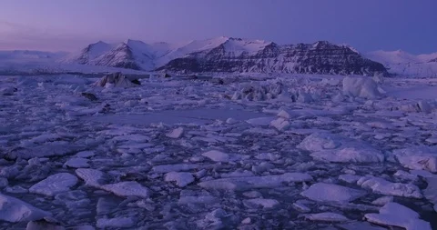 Low flying over glacier lagoon in Iceland at sunset, global warming 動画素材 108453875