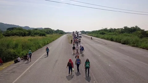 Low flying over Migrant Caravan on the road to USA via Mexico 2018 Editorial 4K Video stock 109228779