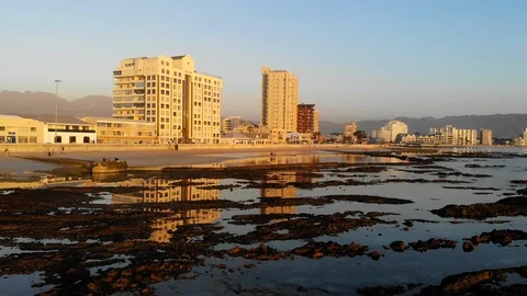 Low flying over reflection in water the beach Strand, Cape Town, South Africa Video stock 98611126