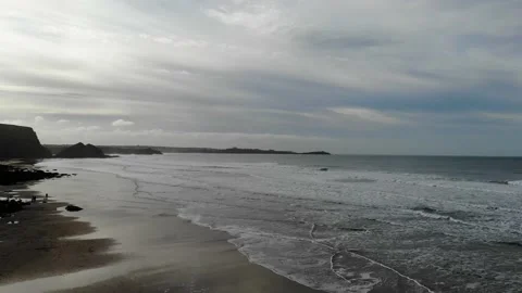 Low flying shot Going Out To Sea over Watergate Bay at sunset Stock Footage 134403040