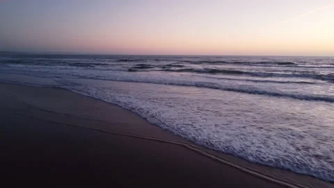 Low Flying Shot of Waves during Sunset at Costa da Caparica beach, Portugal Video stock 145560551