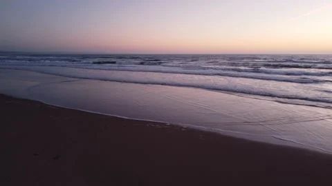 Low Flying Shot of Waves during Sunset at Costa da Caparica beach, Portugal Video stock 145560590