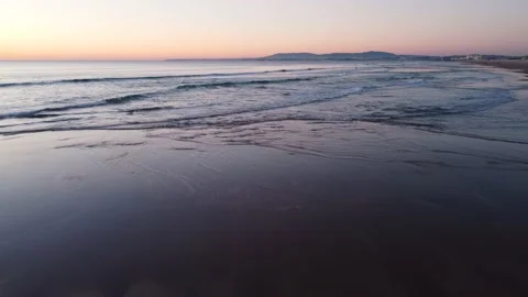 Low Flying Shot of Waves during Sunset at Costa da Caparica beach, Portugal Stock Footage 145702032