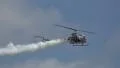 Low Flying Small Helicopter With Smoke Trail HD Footage