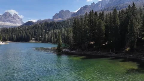 Low Flying Water Surface Drone Push Unveiling Remote Mountain Pass Settl Stock Footage 340382002