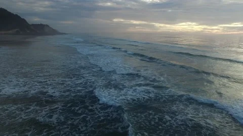 Low flying waves with a beautiful sunset on Oregon Coast Stock Footage 55808342