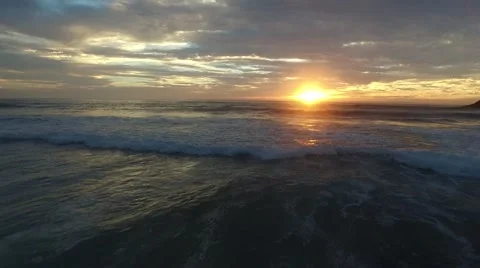 Low flying waves into sunset on Oregon Coast Stock Footage 55809329