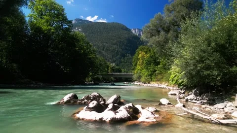 Low flyover of a glacial river running through a green mountain valley Stock Footage 250524923