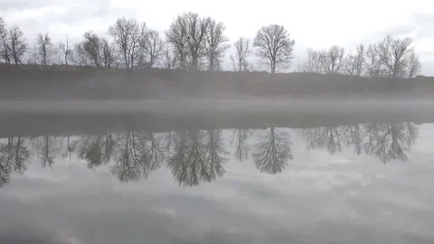 Low fog over the river in the early morning. Beautiful dreamy view Stock Footage 233744331