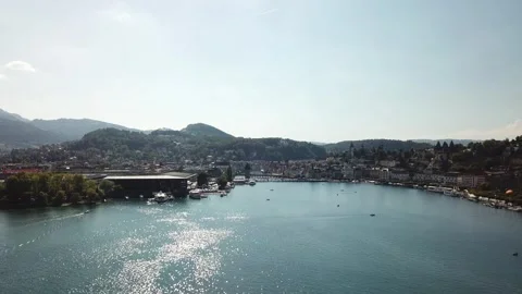 Low forward approach to Lucerne waterfront and KKL roof Stock Footage 331897104