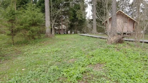 Low forward drone flight through forest camp Stock Footage 329742548