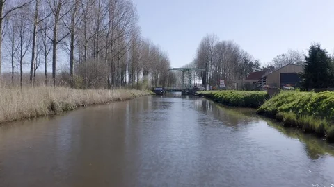 Low forward flying drone shot with tilt reveal of low bridge over river Stock Footage 126863893