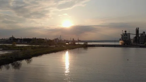 Low Forward Move Toward Industrial Harbor At Sunset Passing Several Large Boats Video stock 112580976