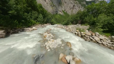 Low FPV Drone Flight Through Alpine River and Forest – Switzerland Stock Footage 313004259