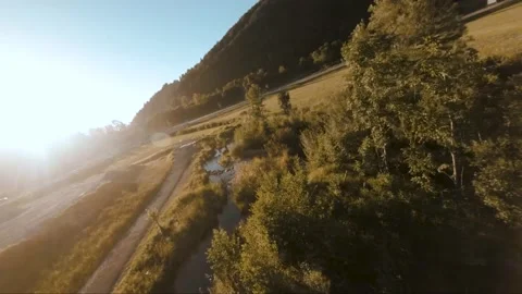 Low FPV river drone shot with scenic landscape and trees during sunset Stock Footage 138038155