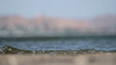 Low frame shot of water breaking on lake shore Stock Footage 8958670