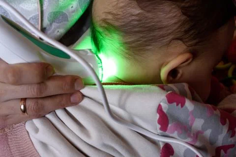 Low-frequency electrotherapy using a green lamp also know as low leverl laste Stock Photos