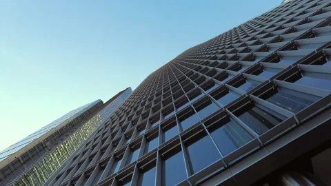 Low generic upward-looking aerial view of city commercial building with blue sky 動画素材 158767573