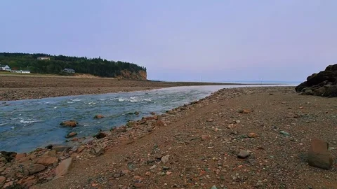 Low Ground Level Shot Of Water Flowing Into The Atlantic Ocean From A Harbor Stock Footage 255335720