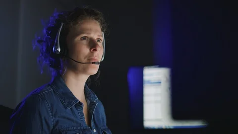 Low handheld view of female support technician focused on computer screens Video stock 126674594